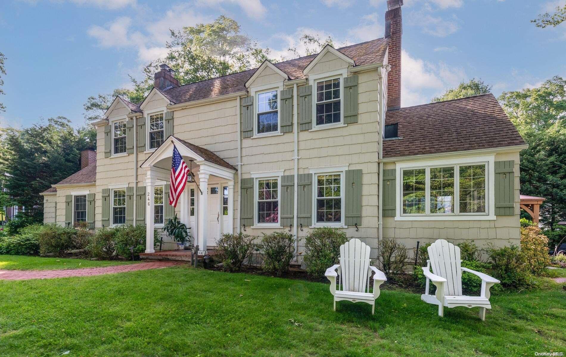 a view of a house with a yard and porch