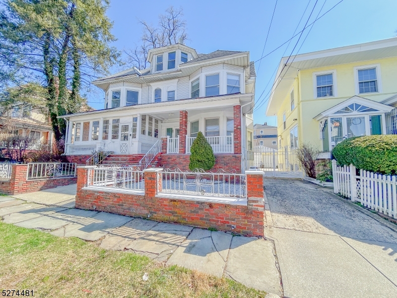 a view of a house with wooden fence