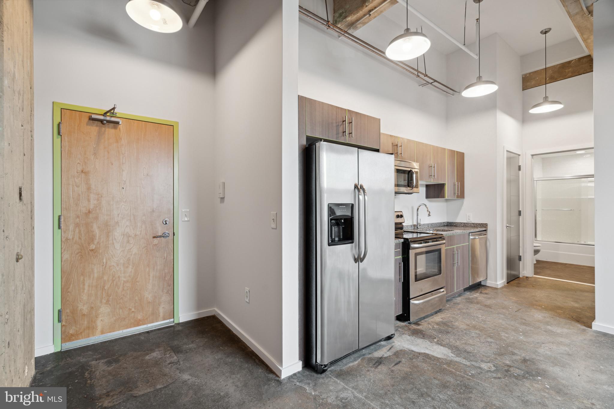 a kitchen with stainless steel appliances a refrigerator and a sink