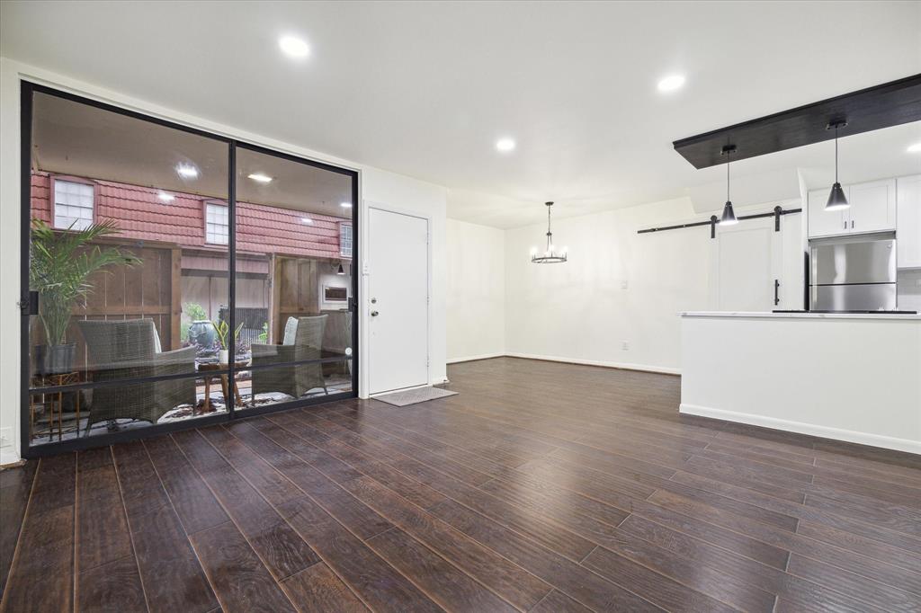 a view of a room with wooden floor and window