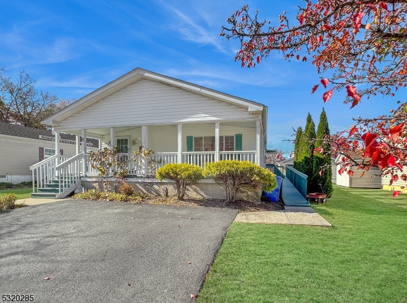 a view of a house with backyard porch and sitting area