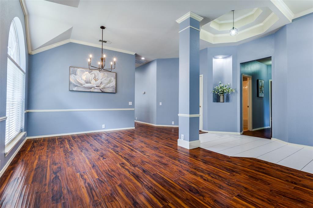 a view of a room with wooden floor chandelier and entryway