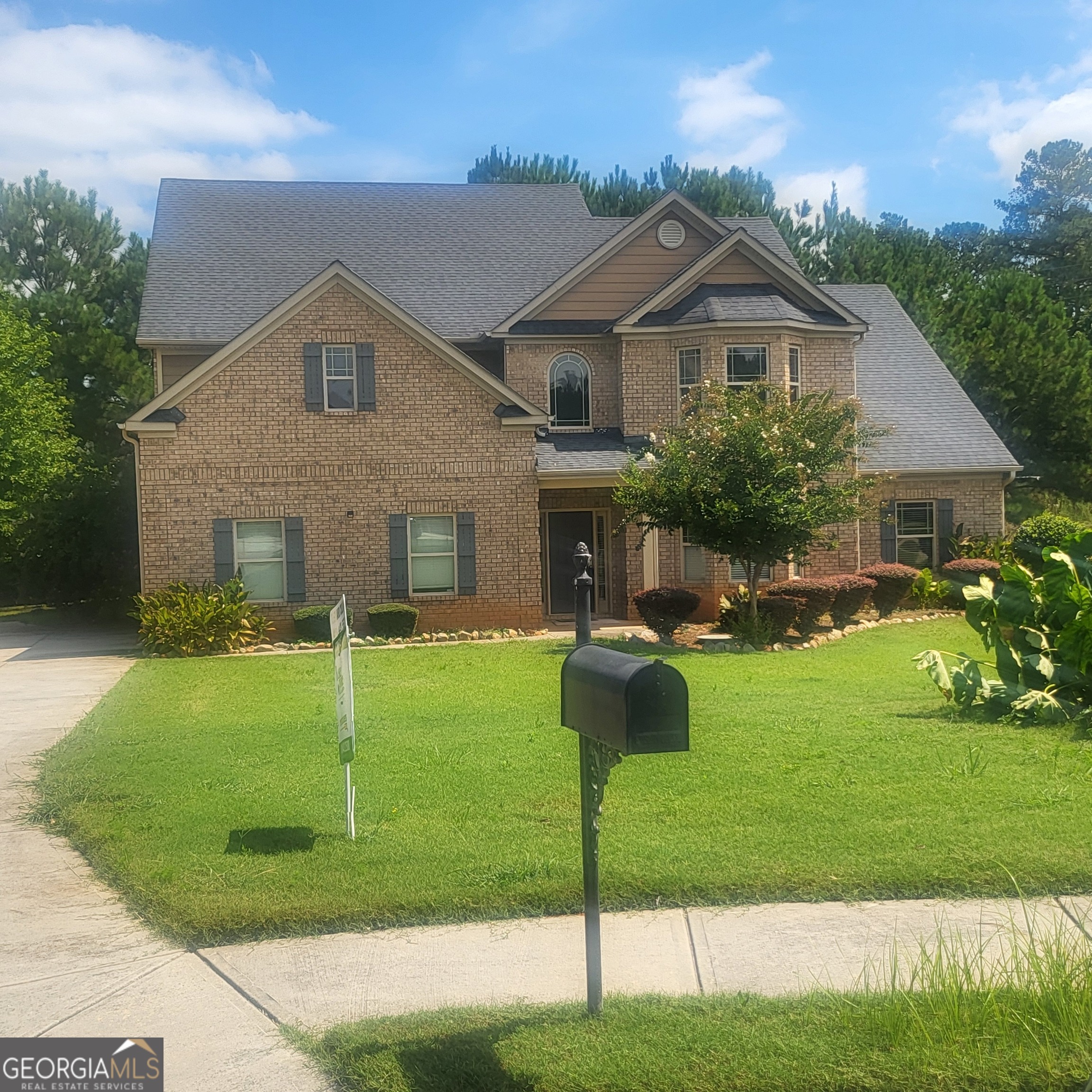 a front view of a house with garden and porch