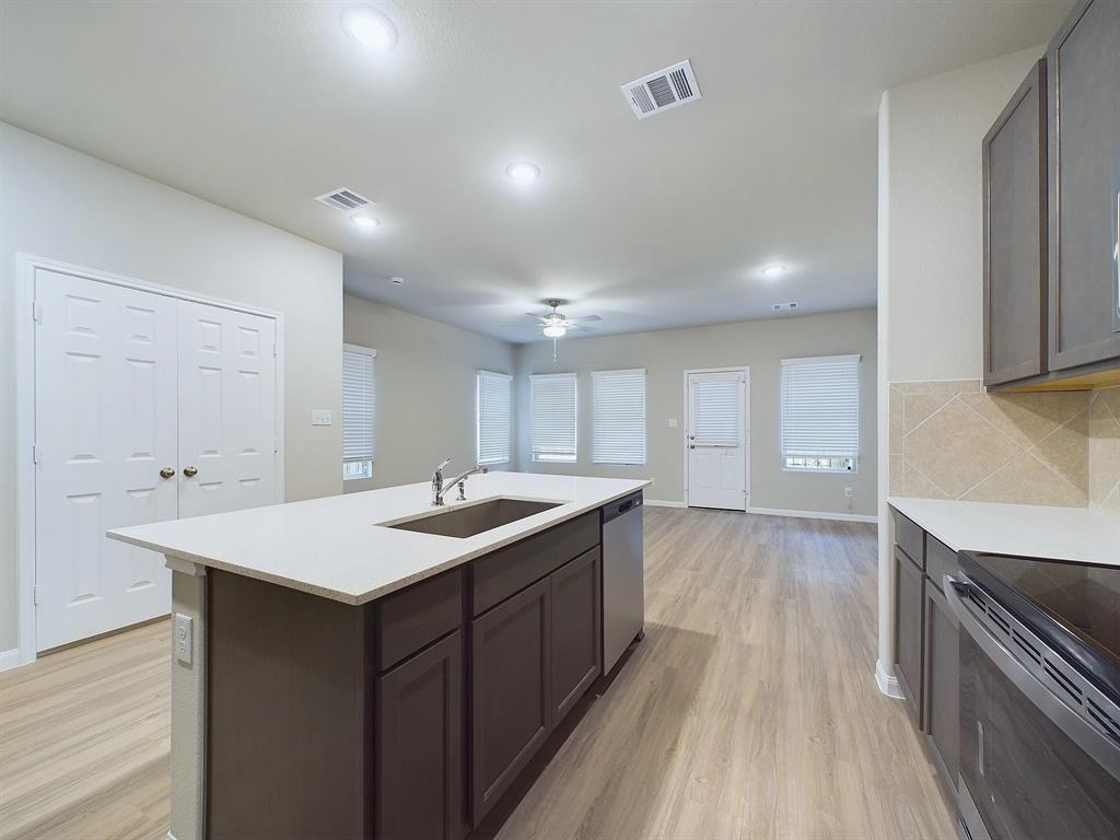 a kitchen with a sink stove and cabinets