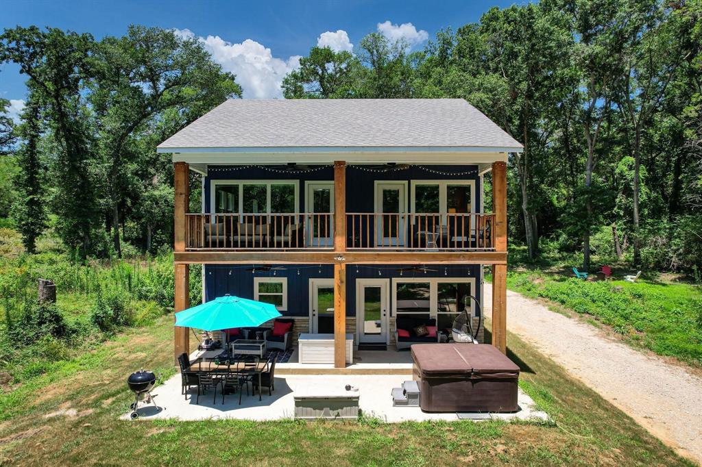 a view of a house with a yard and sitting area