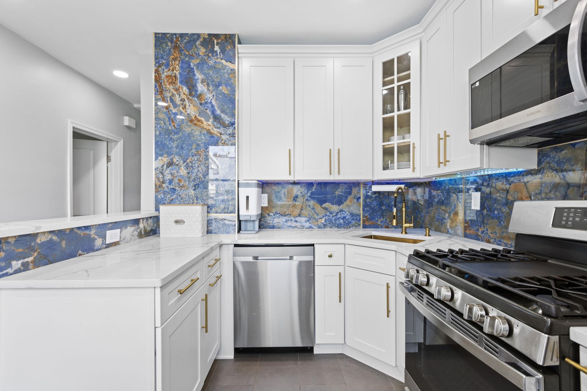 a kitchen with white cabinets and appliances