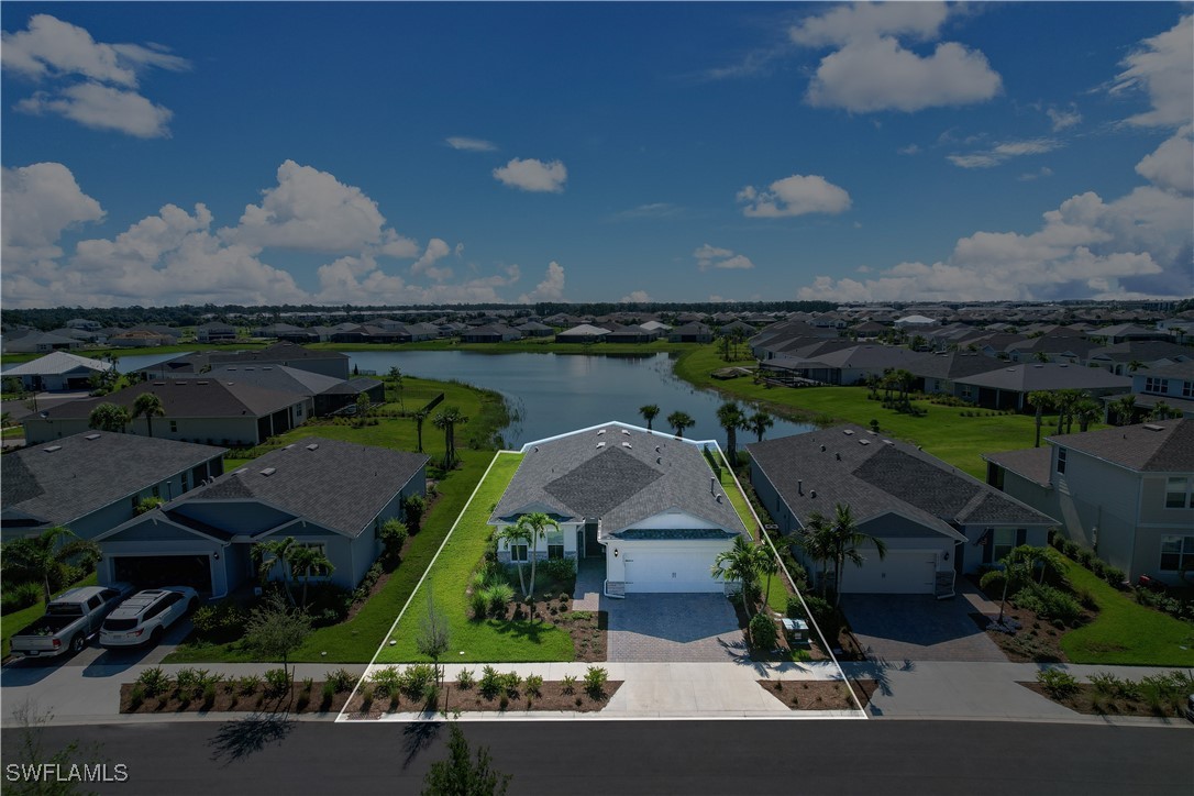 an aerial view of a house with garden space lake view and mountain view