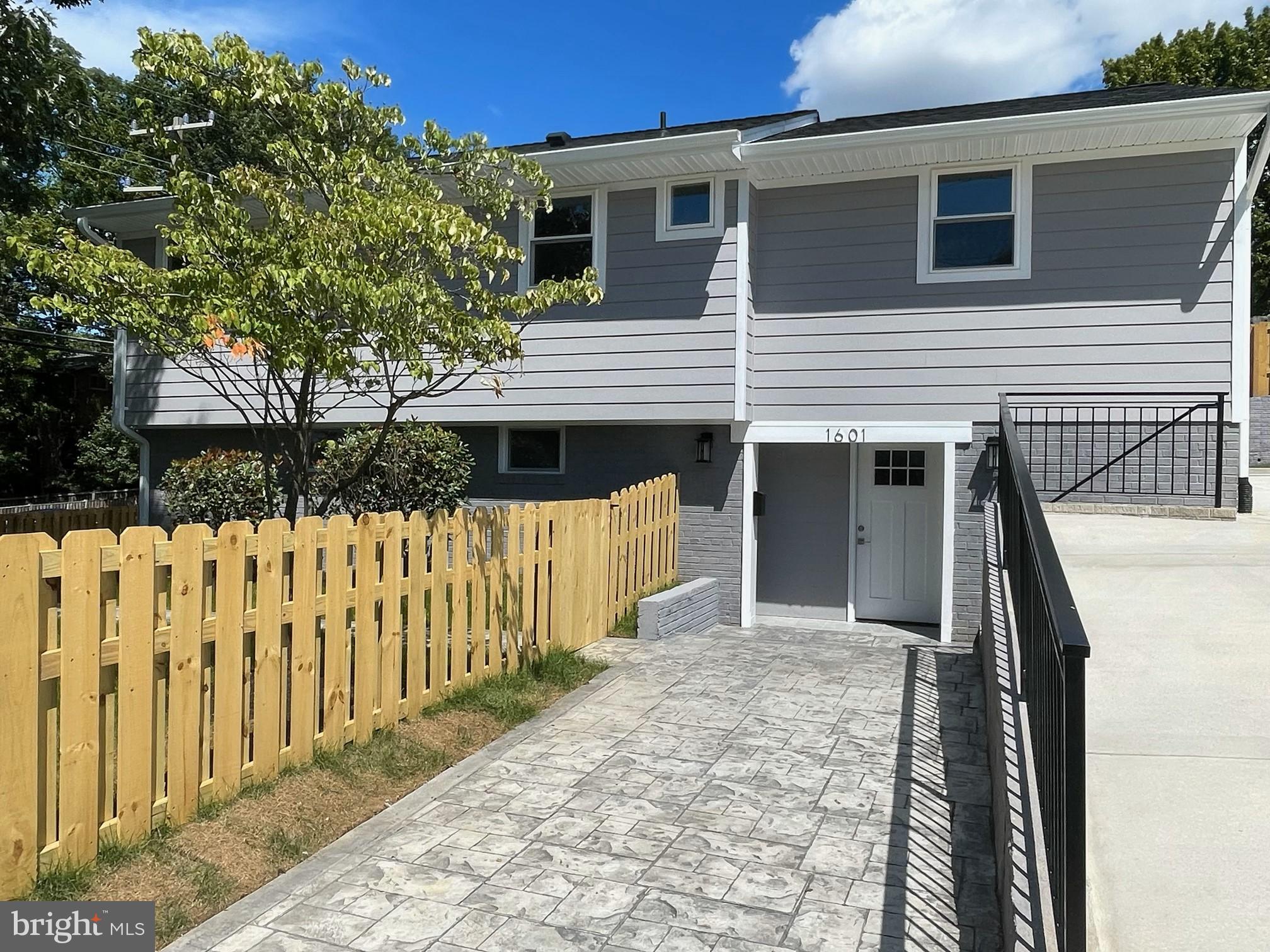 a front view of house with wooden fence