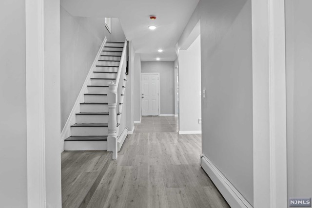 a view of entryway with wooden floor