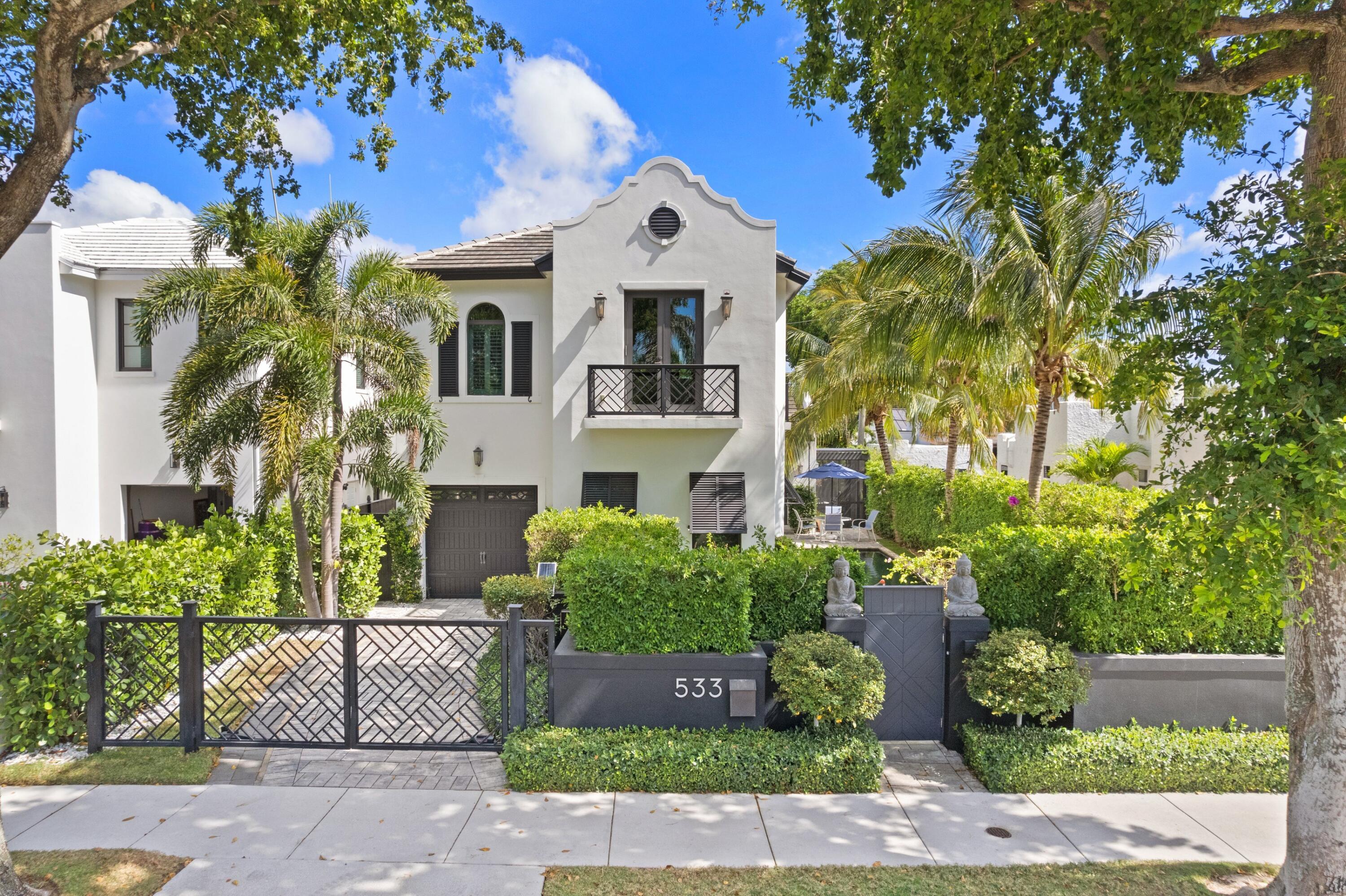 a front view of a house with a garden