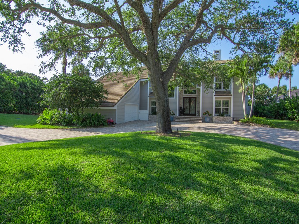 a view of a house with a tree and a yard