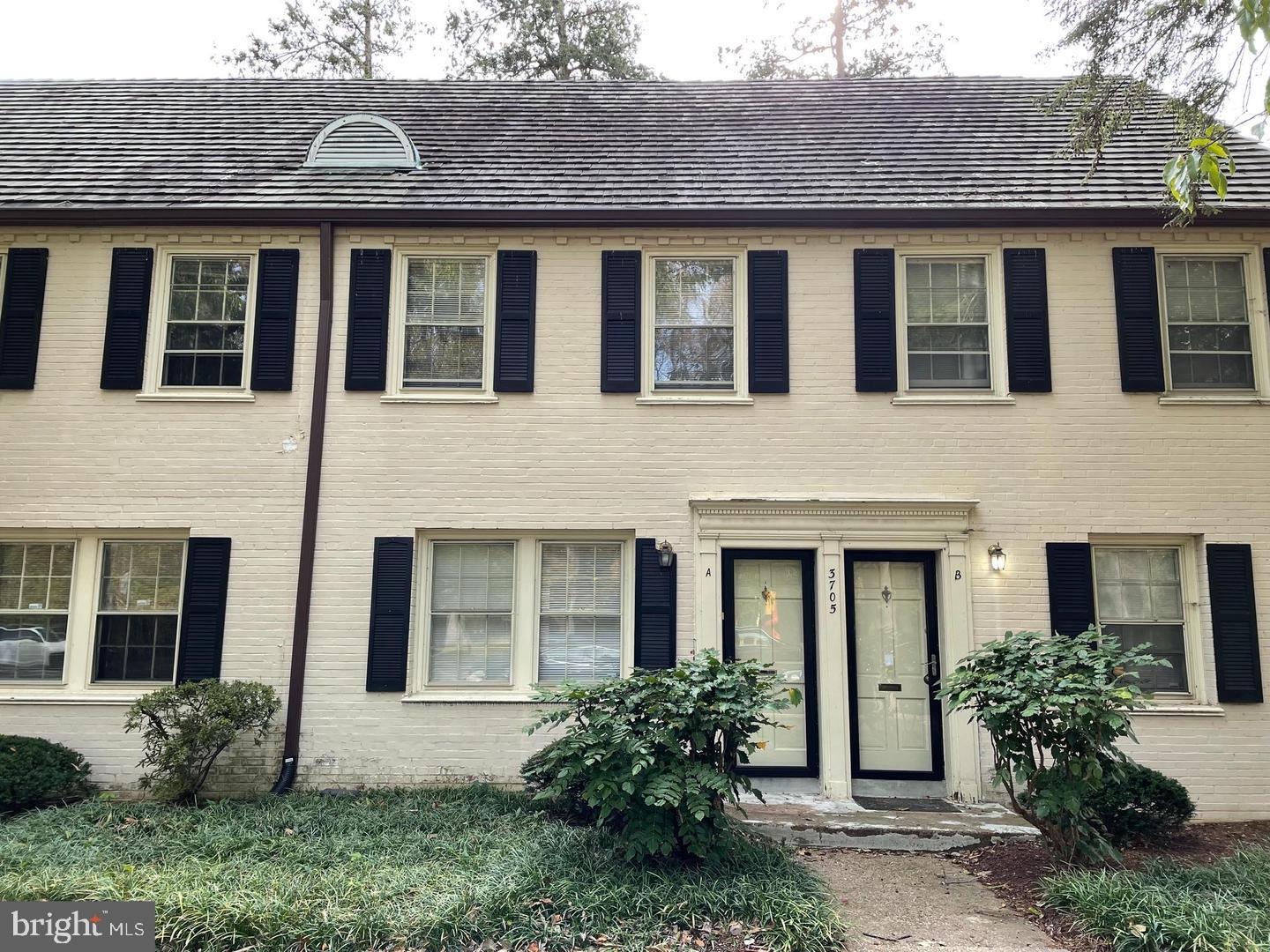 a front view of house with a garden