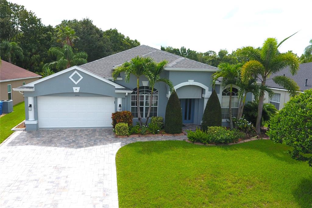 a front view of a house with a yard and garage