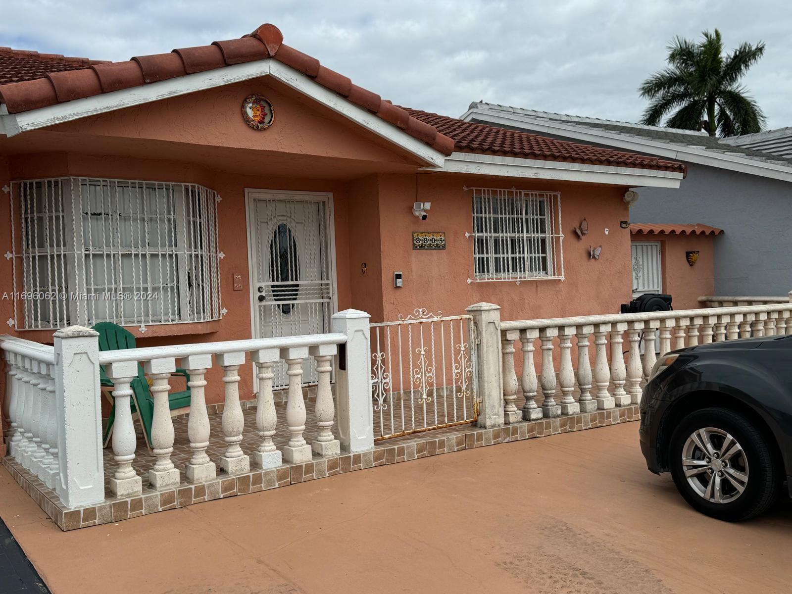 a view of a house with a small yard and furniture