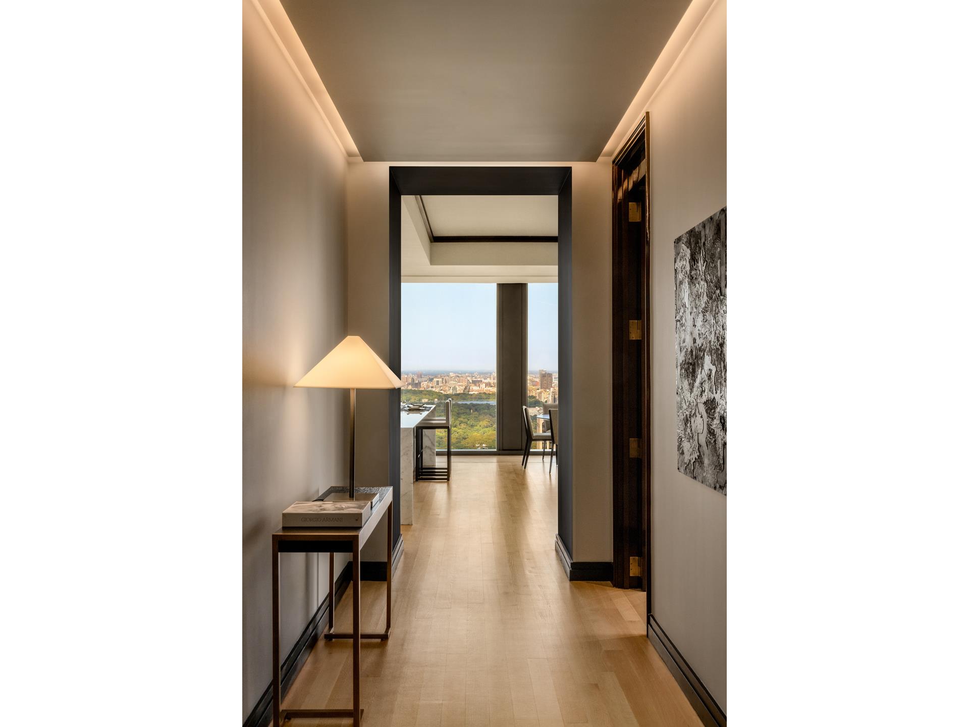 a view of a hallway with furniture and chandelier