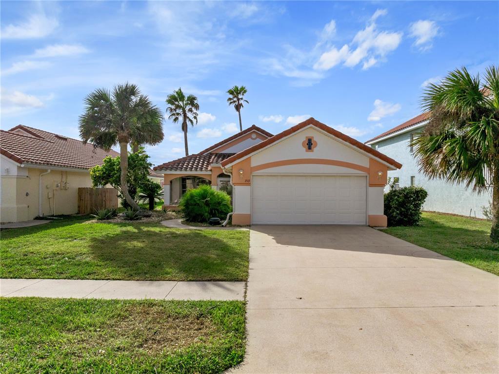 a front view of a house with a yard and garage