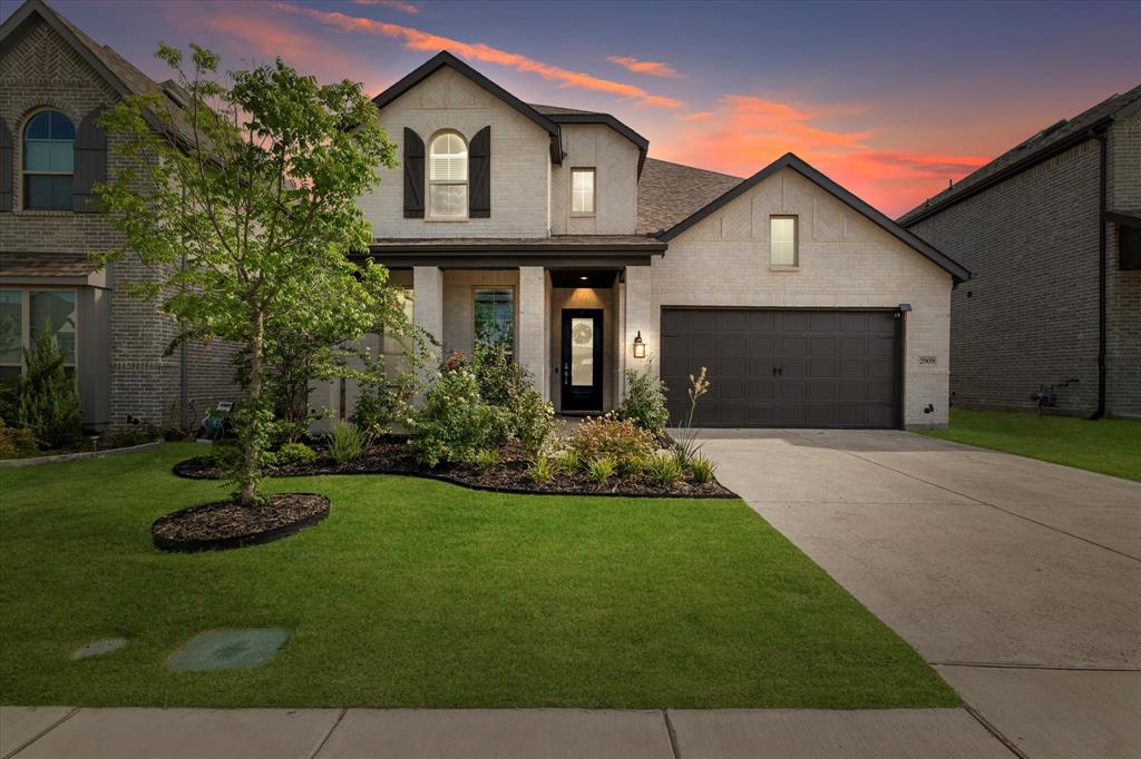 a front view of a house with a yard and garage