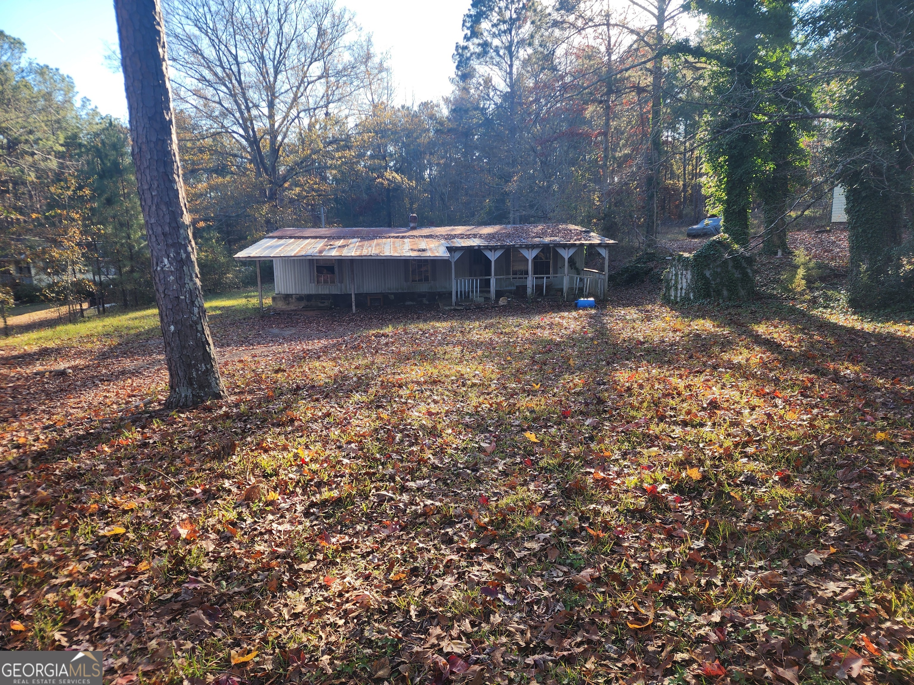 a view of a house with a yard and sitting area