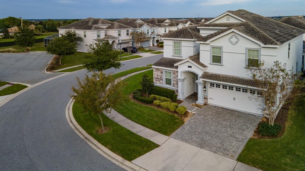 an aerial view of a house with a yard