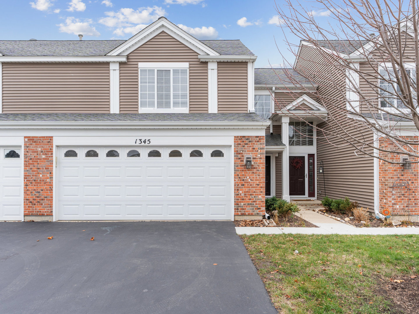 a front view of a house with garage