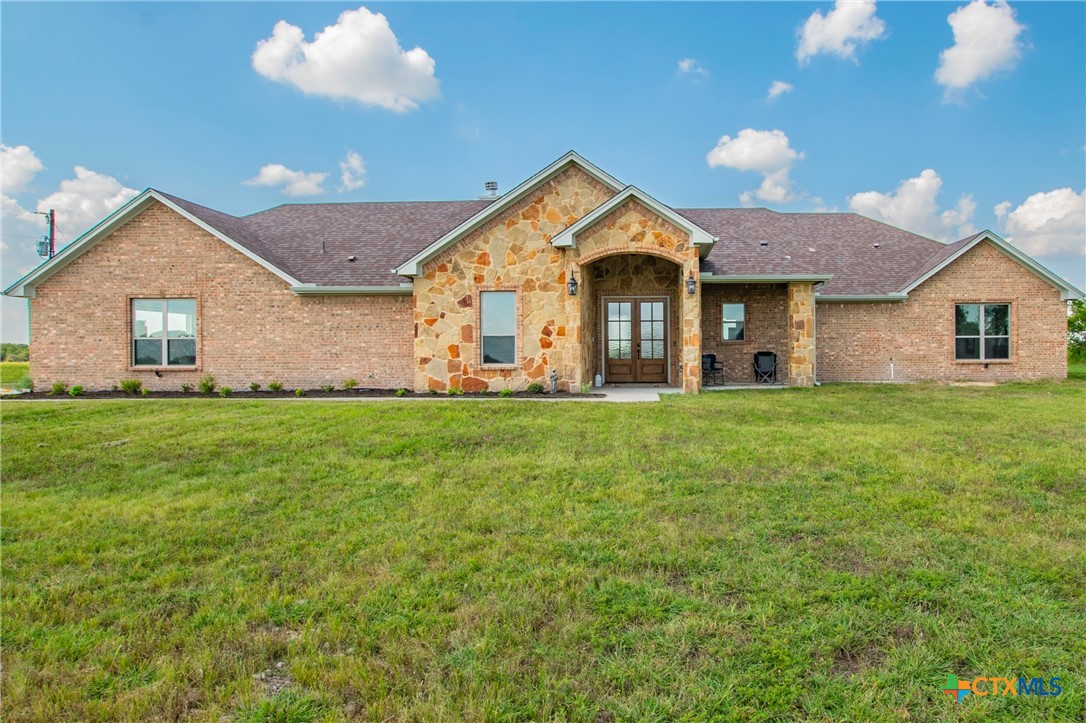 a front view of house with yard and green space