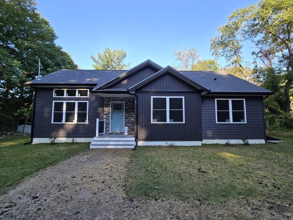 a front view of a house with a garden