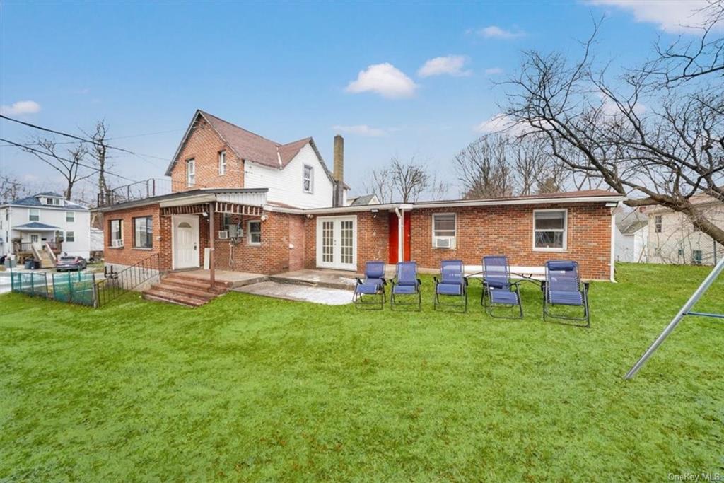 a view of a house with a yard porch and sitting area