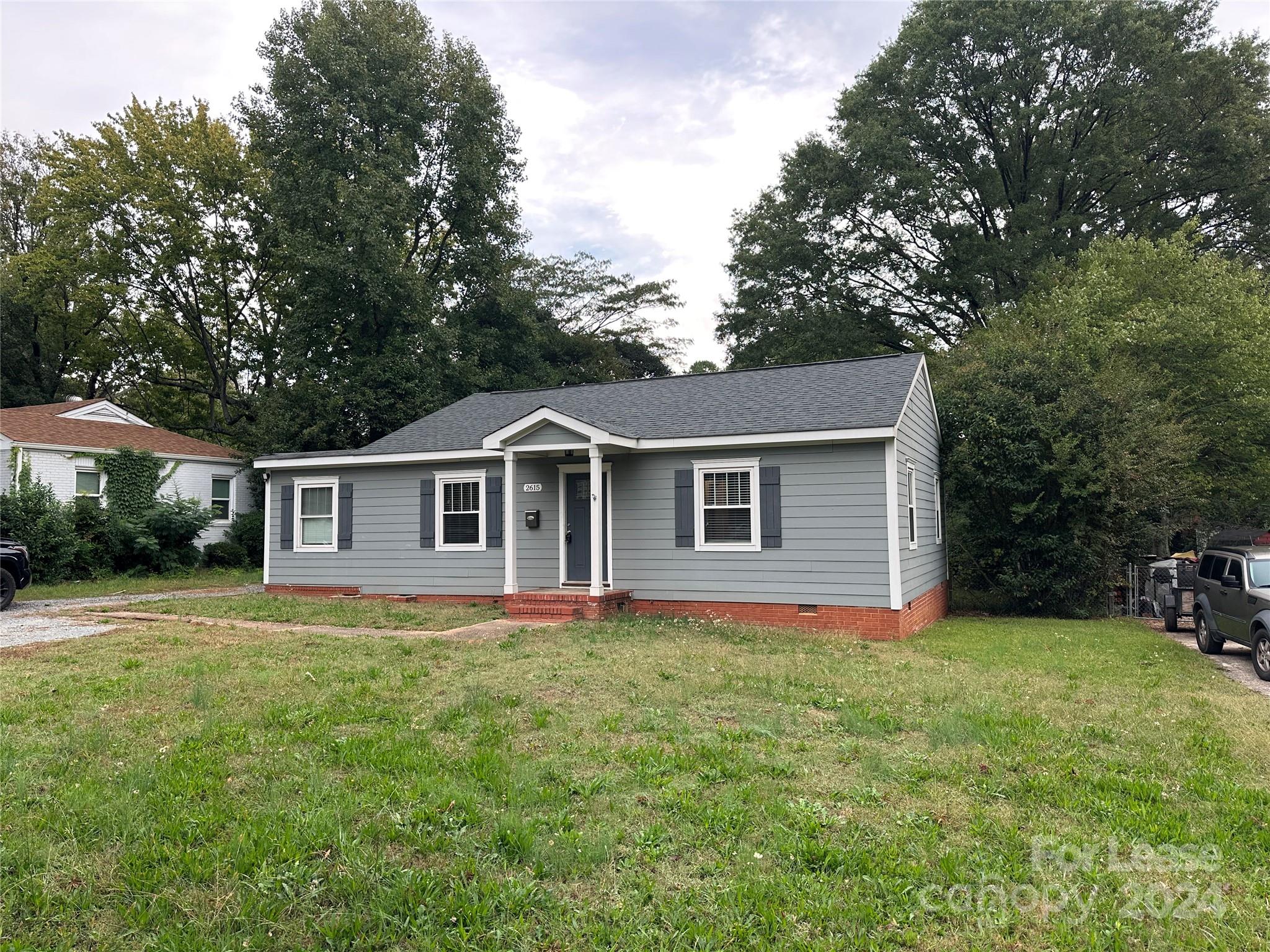 a front view of house with yard and trees