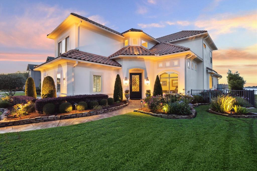 a front view of a house with a yard fire pit and chairs