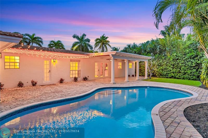 a swimming pool with outdoor seating