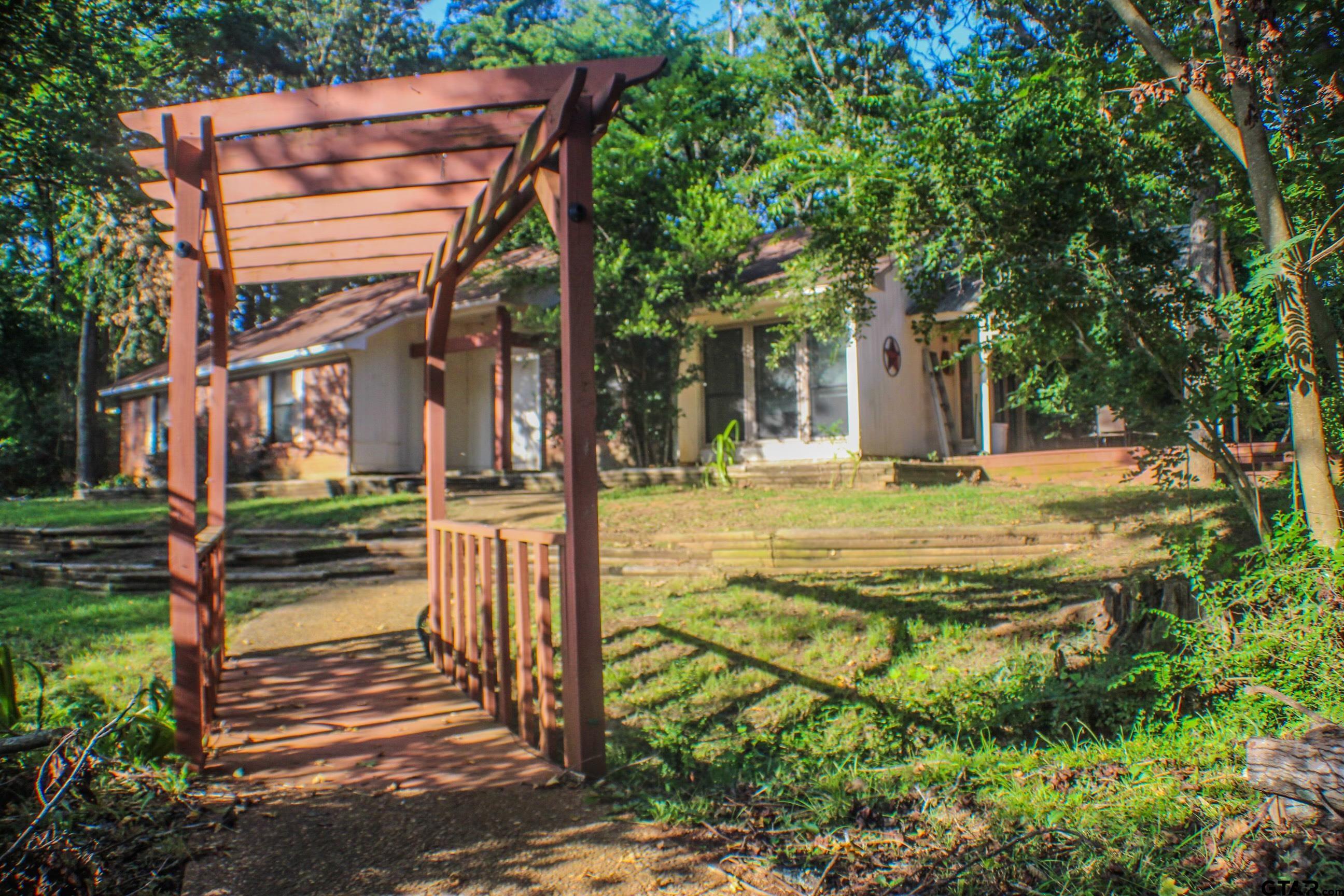 a view of a house with backyard and sitting area