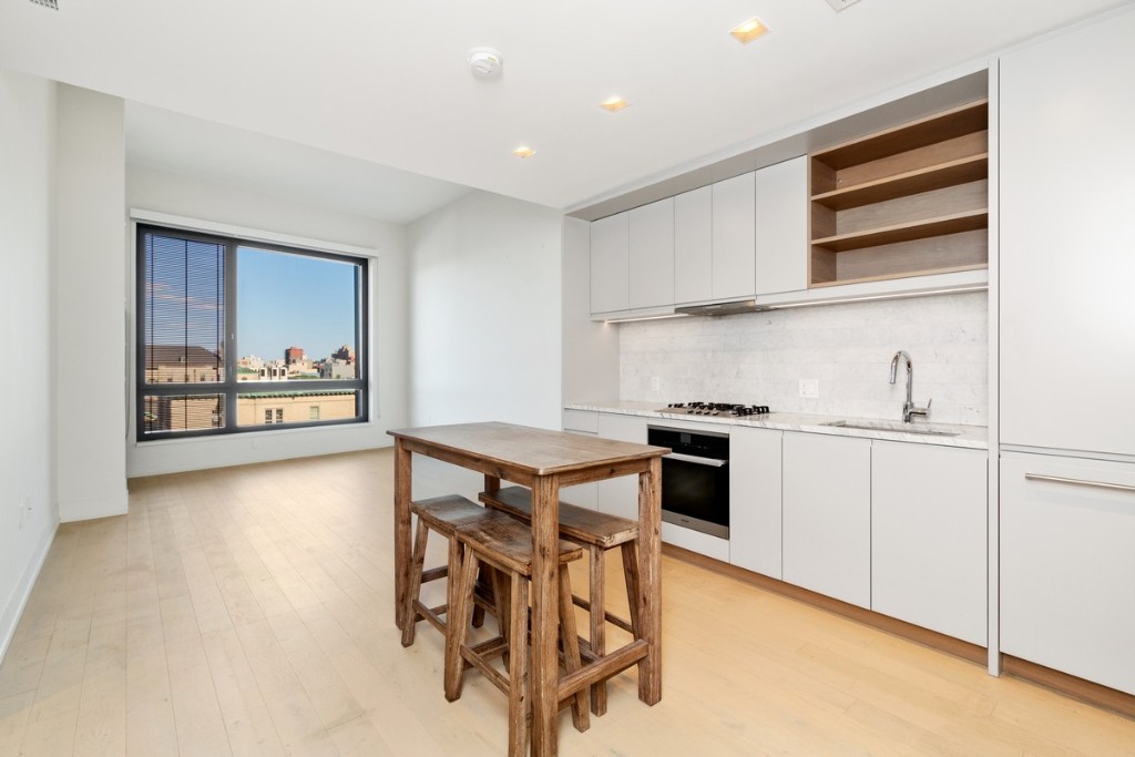 a kitchen with stainless steel appliances granite countertop a stove and a refrigerator