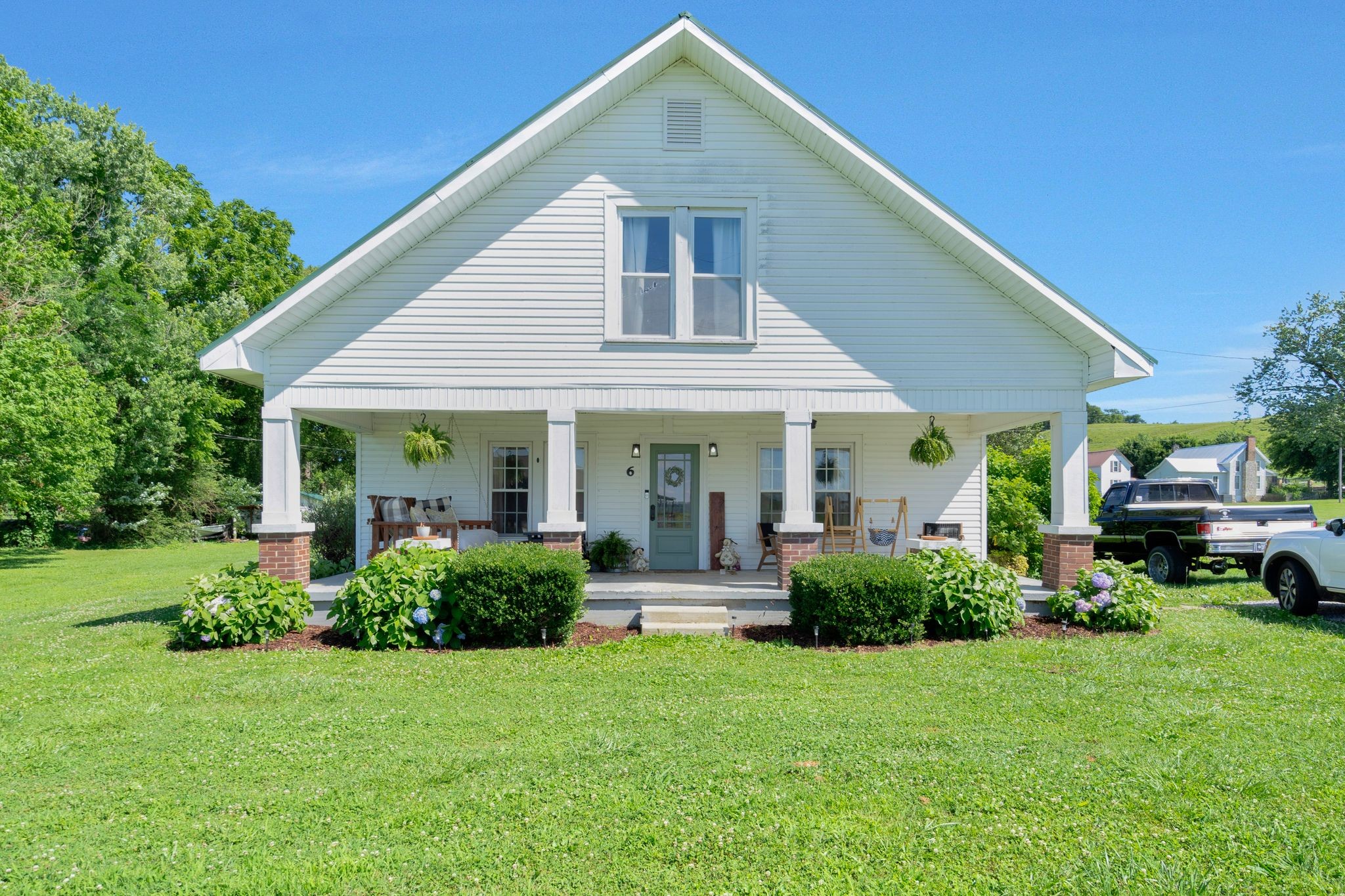 a front view of a house with garden and porch