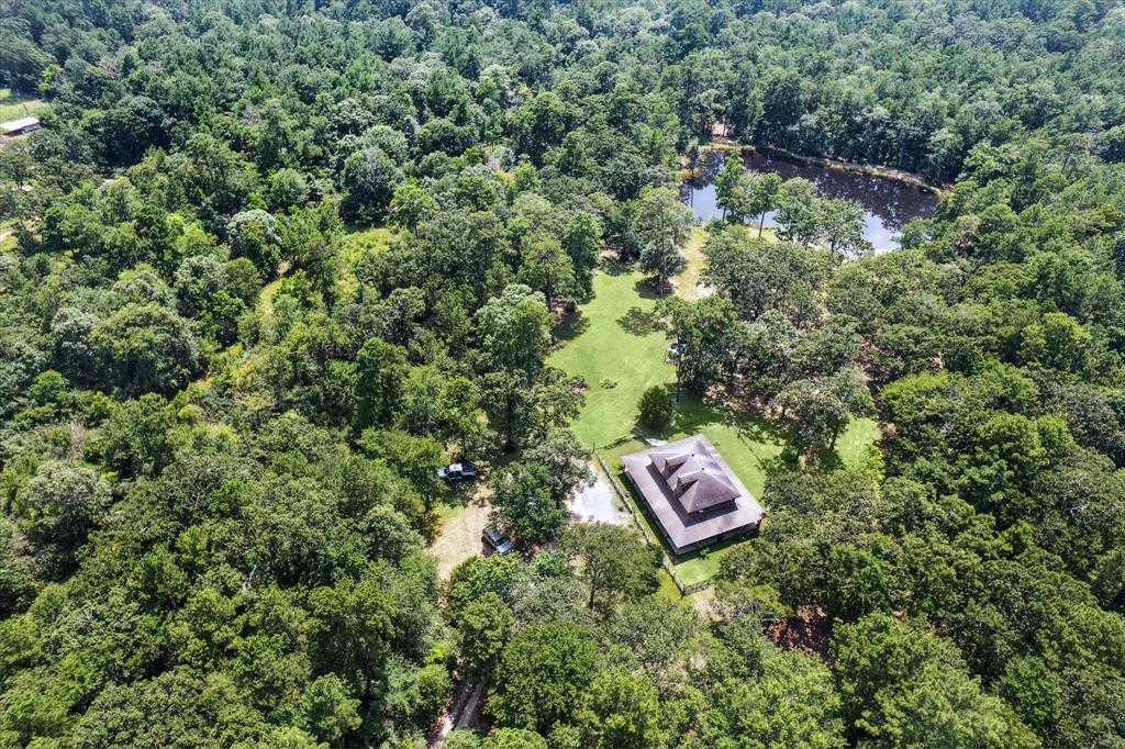 an aerial view of a house with a yard