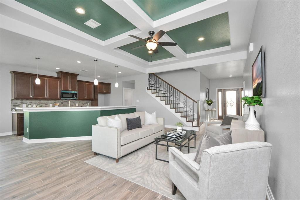 a living room with furniture and a wooden floor