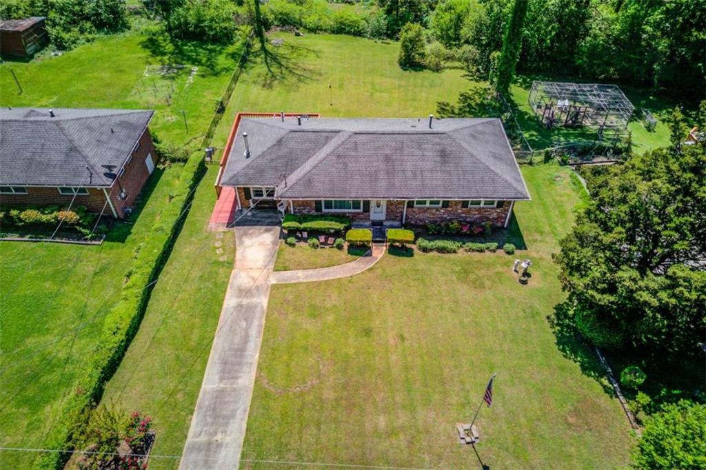 an aerial view of a house with swimming pool garden and patio