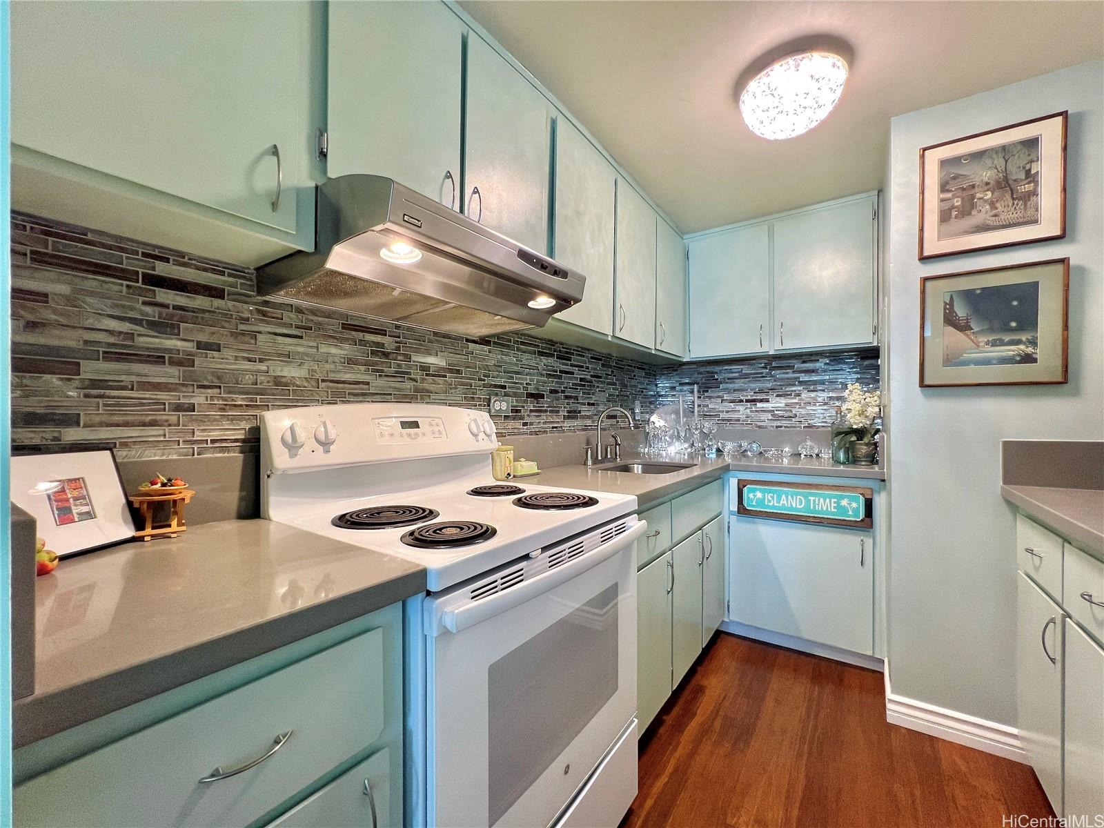 a kitchen with stainless steel appliances a stove a sink and a microwave