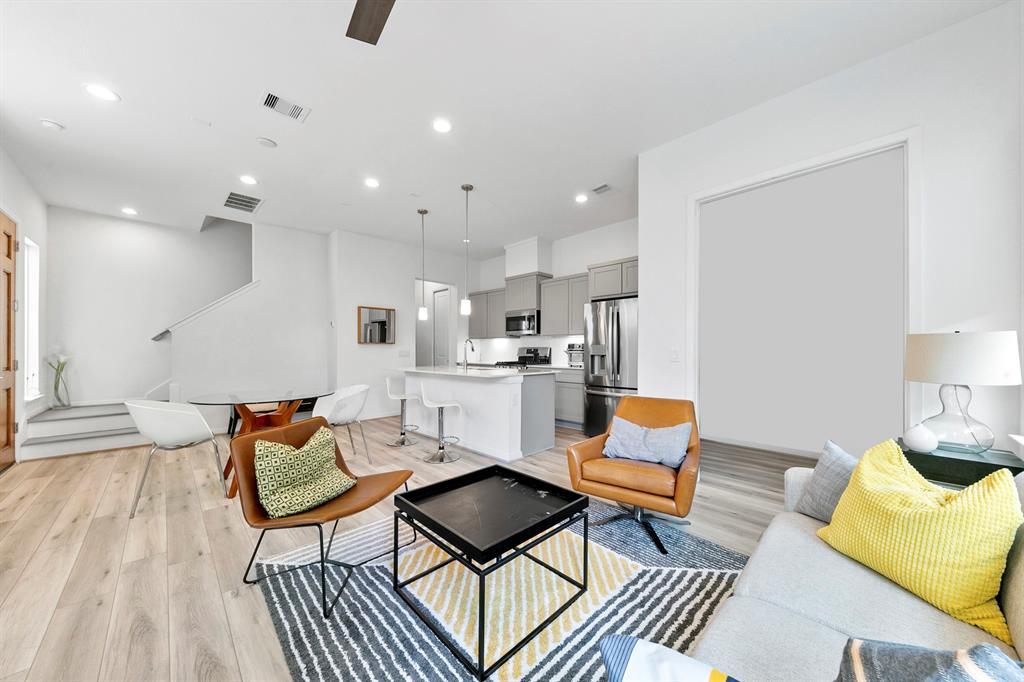 a living room with furniture and kitchen view