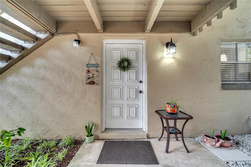 a view of an entryway with a flower pot and table in a room