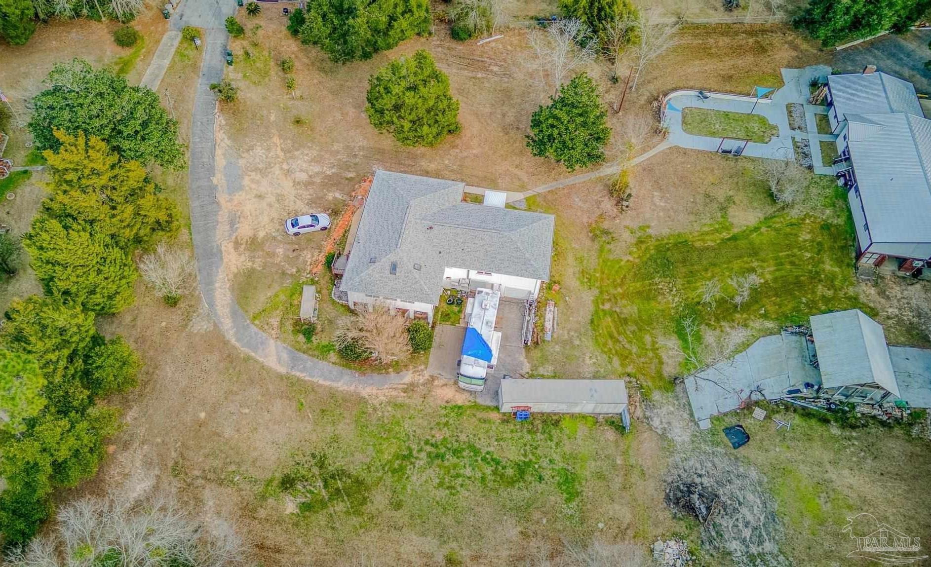 an aerial view of a house with outdoor space