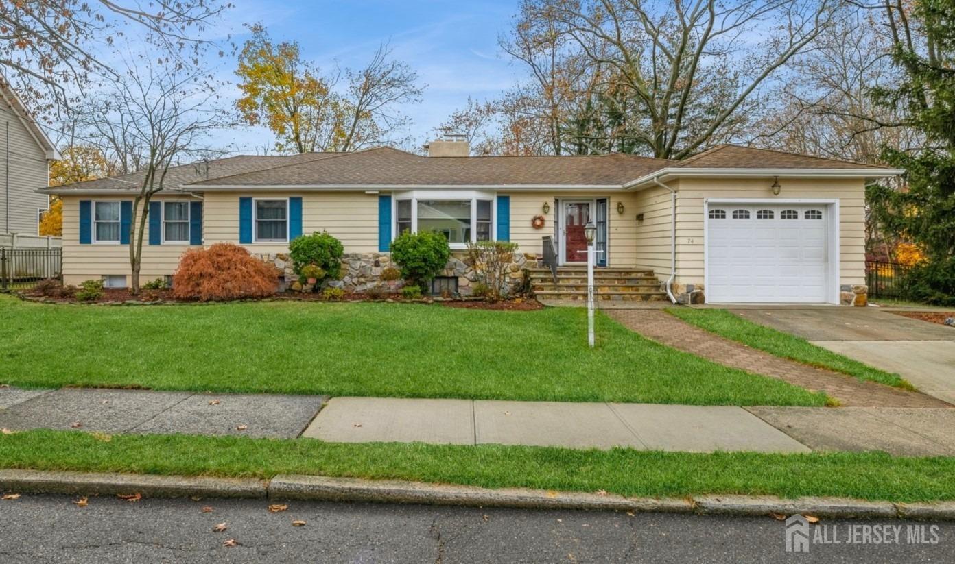 a front view of a house with a garden and yard