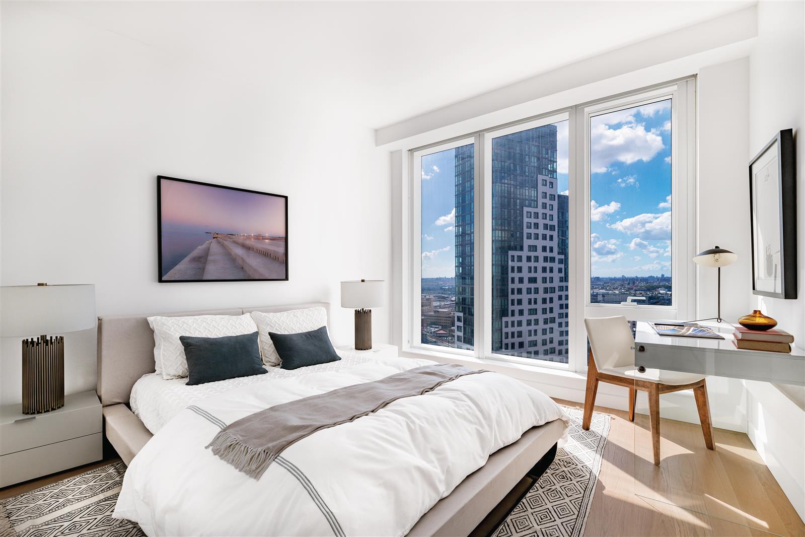 a bedroom with a bed and a painting on the wall