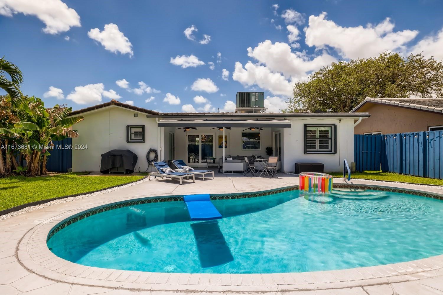 a view of a house with swimming pool having outdoor seating