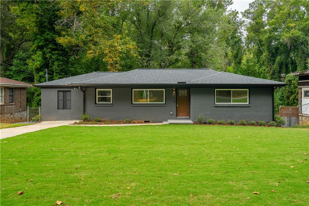 a front view of a house with a garden