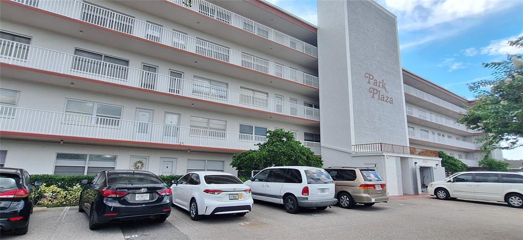 a view of a cars park in front of a building