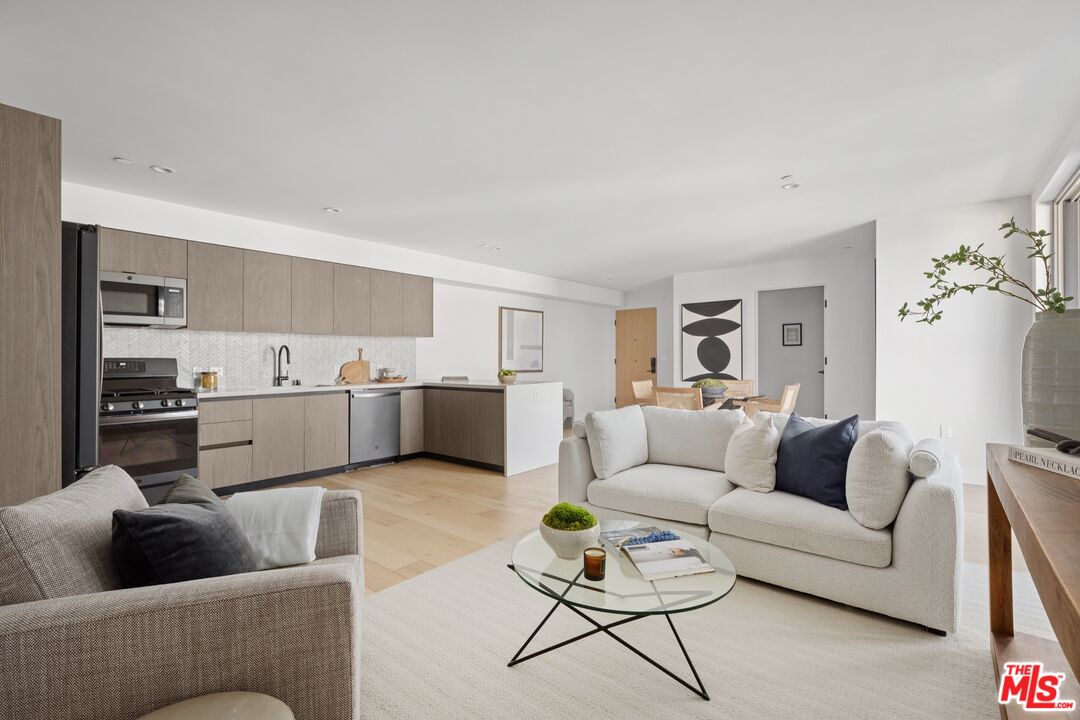 a living room with furniture and kitchen view