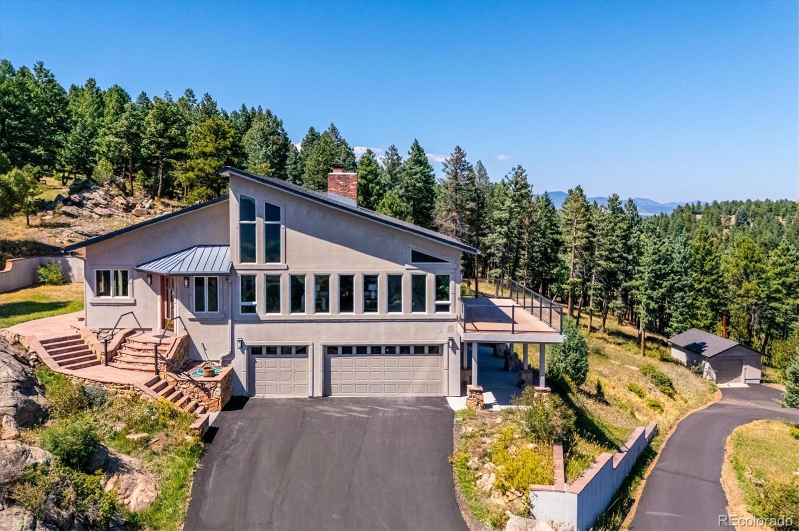 an aerial view of a house with swimming pool in front of it