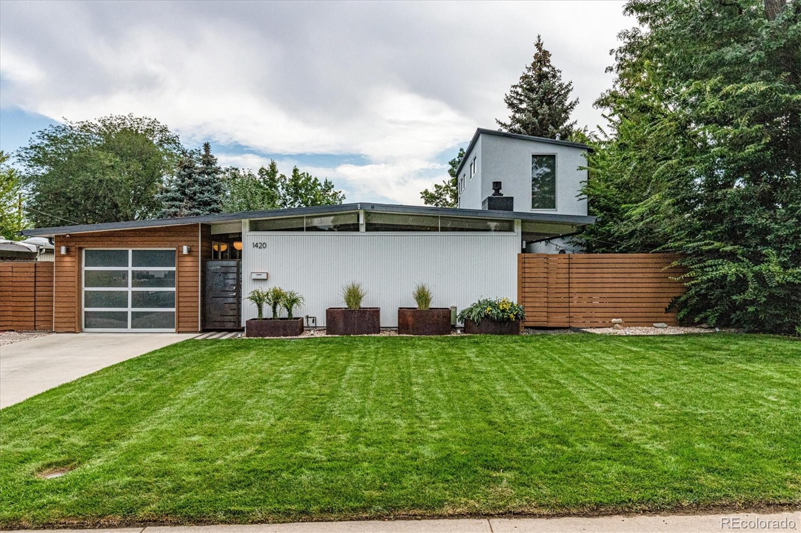 a view of a house with a yard and a garden