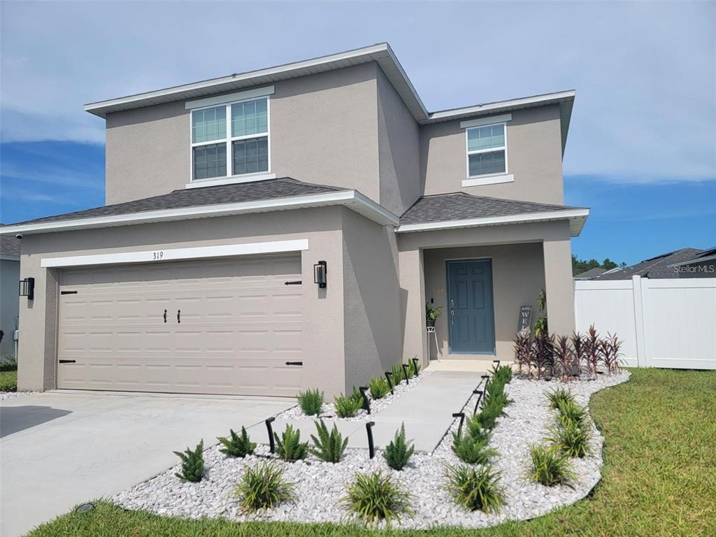 a front view of a house with a yard