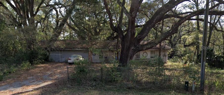 a backyard of a house with table and chairs